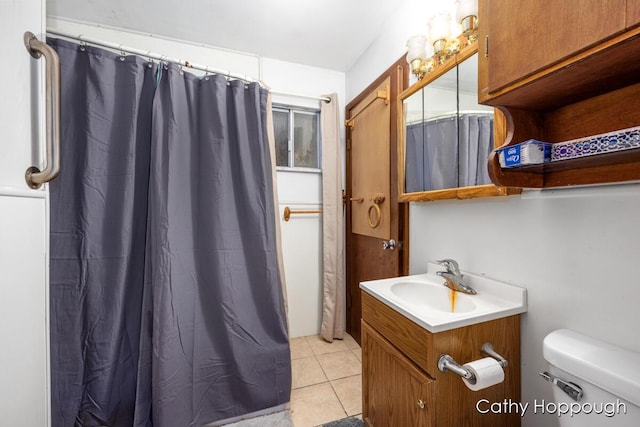 bathroom with tile patterned flooring, vanity, and toilet