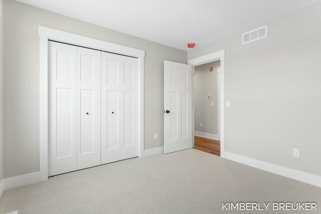 unfurnished bedroom with carpet floors and a closet