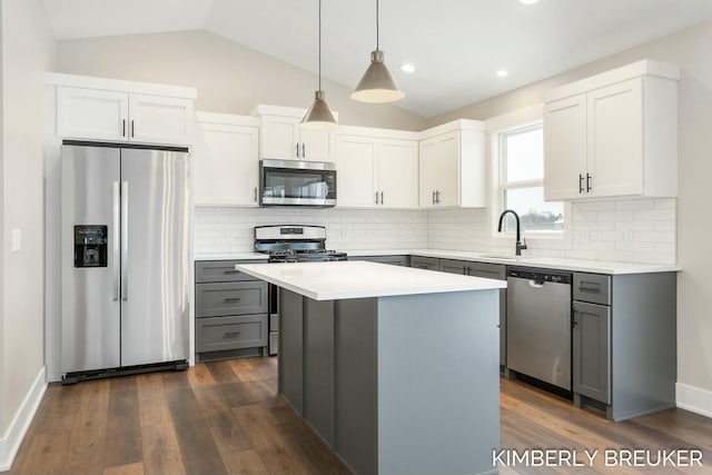 kitchen featuring gray cabinetry, vaulted ceiling, dark hardwood / wood-style floors, white cabinetry, and stainless steel appliances