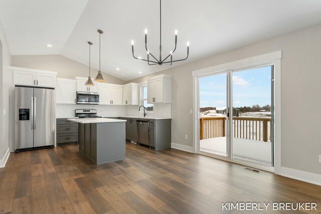 kitchen featuring gray cabinets, white cabinets, dark hardwood / wood-style floors, and appliances with stainless steel finishes