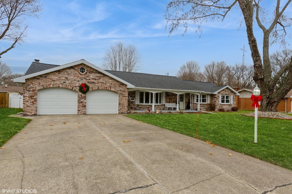 ranch-style home with a front yard, a porch, and a garage