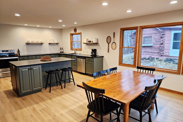 dining room with sink and light wood-type flooring