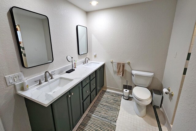 bathroom featuring toilet, vanity, and tile patterned floors