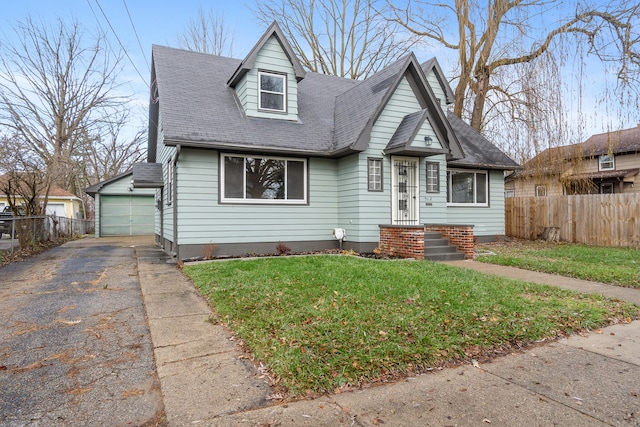 view of front of property with a front yard, a garage, and an outdoor structure