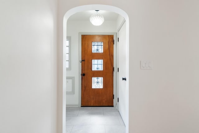 doorway with light tile patterned flooring