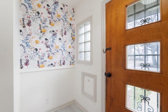 entryway with light tile patterned floors and a wealth of natural light