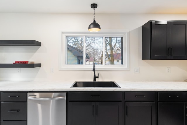 kitchen with light stone counters, dishwasher, pendant lighting, and sink