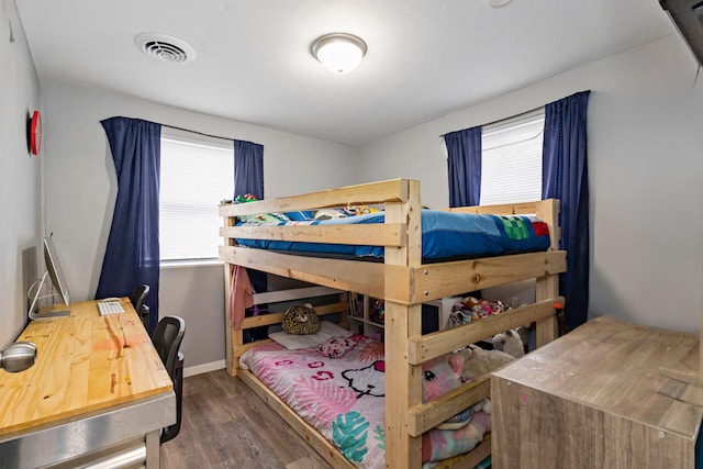 bedroom with dark hardwood / wood-style floors