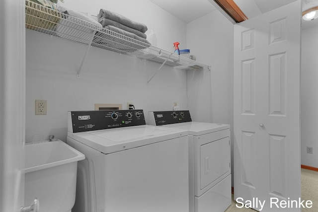 clothes washing area with sink and washing machine and dryer