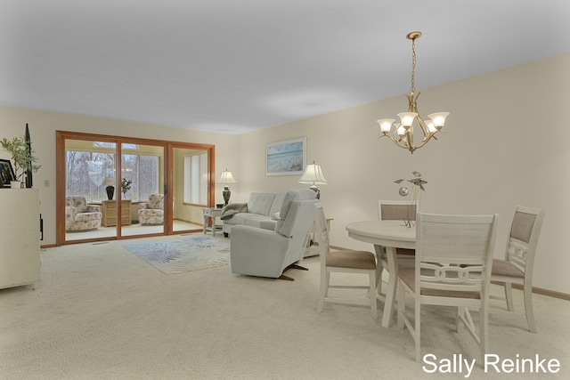 dining room featuring light colored carpet and a notable chandelier