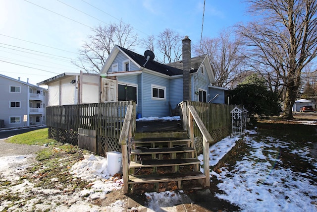 snow covered property featuring a wooden deck