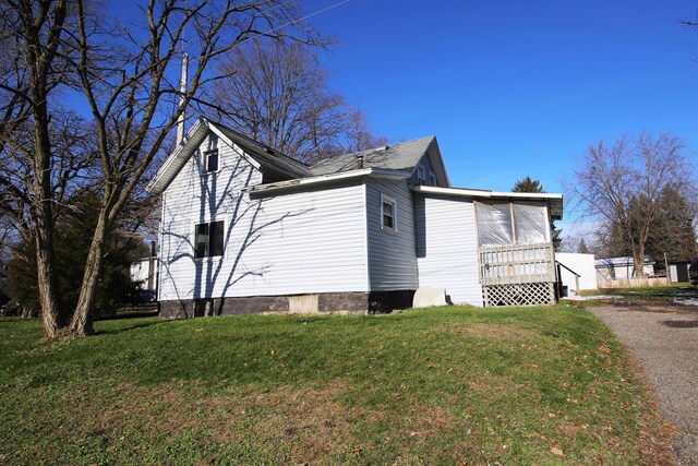 view of side of property with a yard