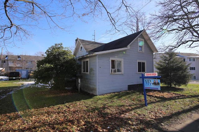 view of home's exterior with a lawn