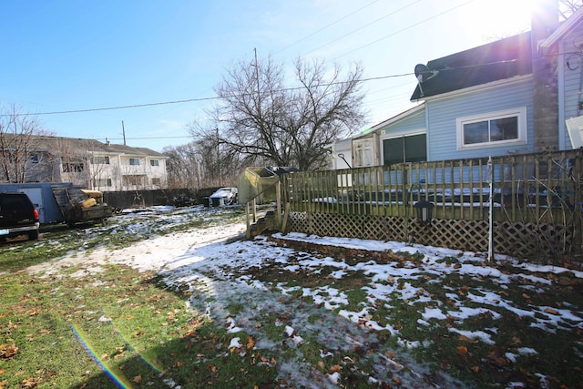 yard layered in snow featuring a wooden deck