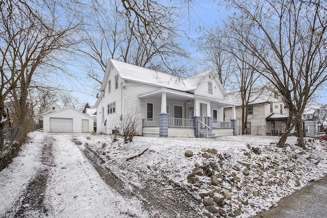 view of front of house featuring a porch, a garage, and an outdoor structure