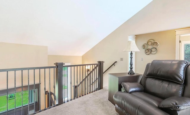 living area featuring carpet flooring and vaulted ceiling