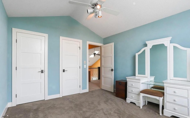 unfurnished bedroom with carpet flooring, ceiling fan, and vaulted ceiling