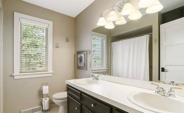 bathroom featuring a chandelier, tile patterned floors, vanity, and toilet