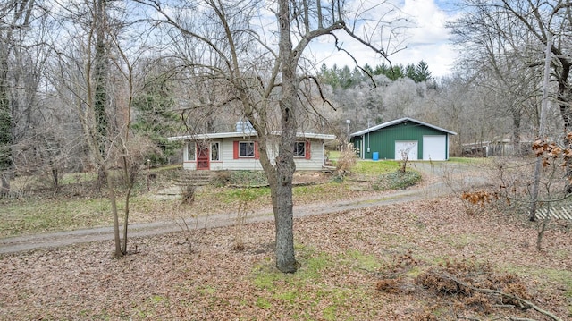 ranch-style house featuring an outbuilding and a garage