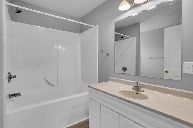 bathroom featuring vanity and  shower combination