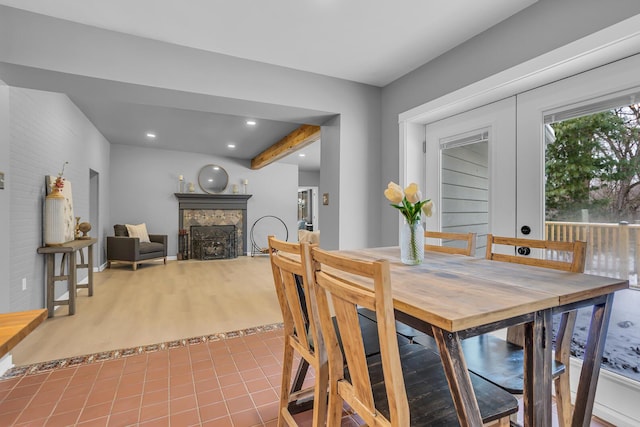 dining area featuring beam ceiling