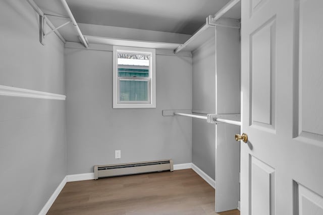 spacious closet featuring baseboard heating and light wood-type flooring