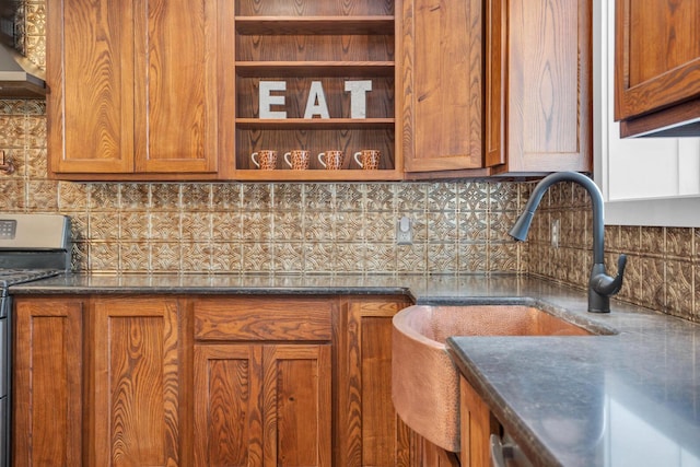 kitchen with dark stone countertops, decorative backsplash, stainless steel stove, and extractor fan