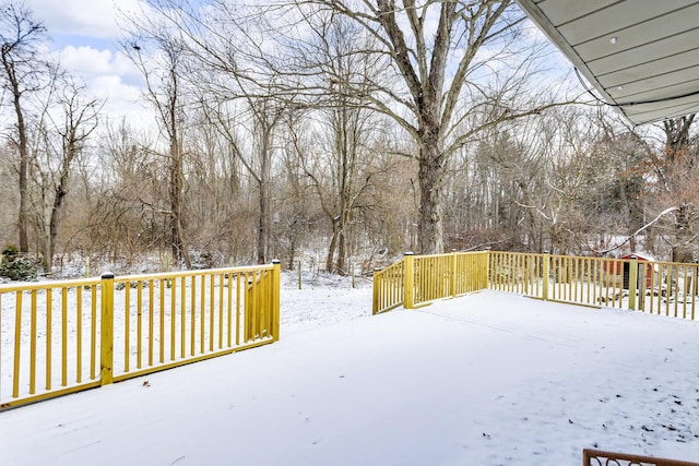 yard covered in snow with a deck