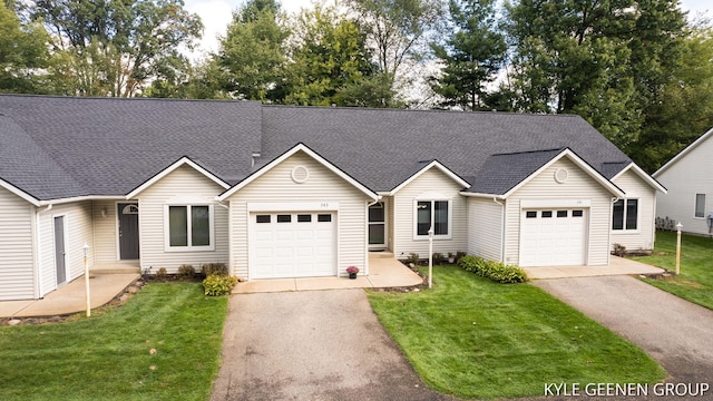 single story home featuring a garage and a front lawn