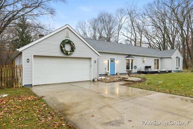 ranch-style home with a garage and a front lawn