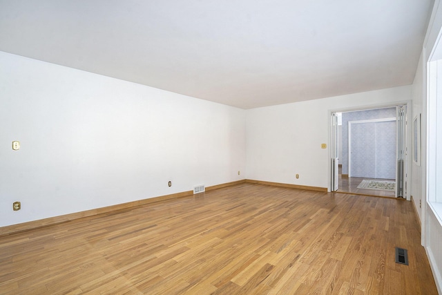 spare room featuring light wood-type flooring