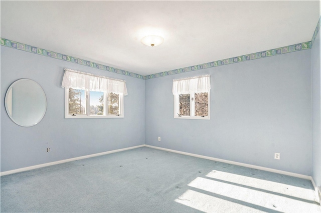 carpeted empty room with a wealth of natural light