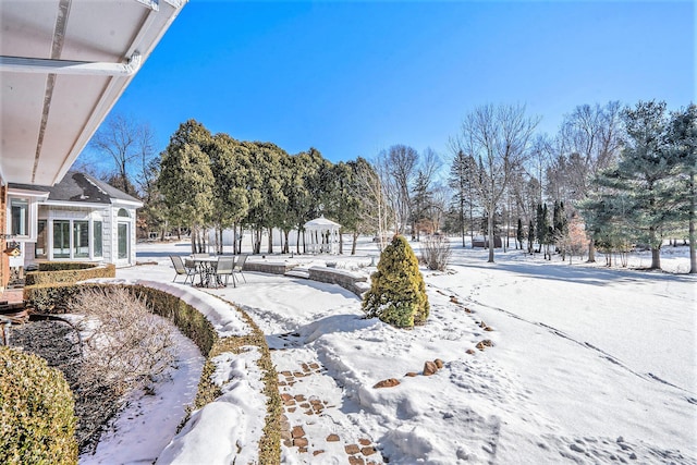 yard layered in snow featuring a gazebo