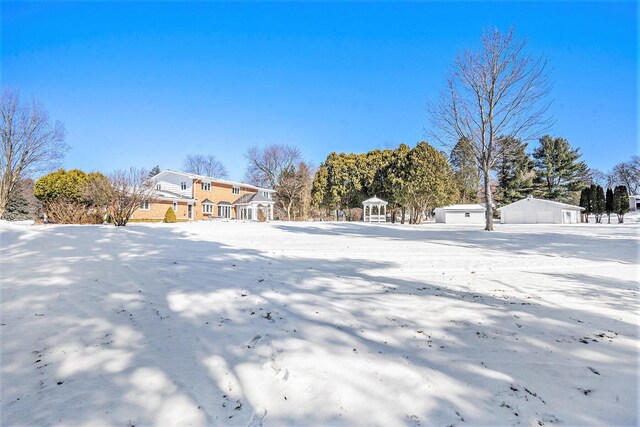 view of yard layered in snow