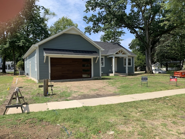 view of front of home featuring a garage and a front lawn