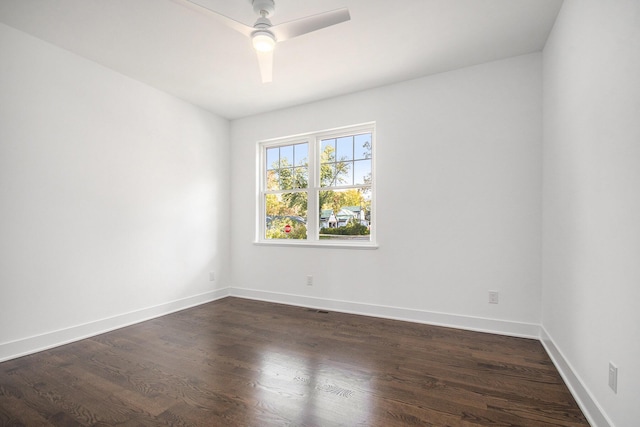 unfurnished room featuring ceiling fan and dark wood-type flooring