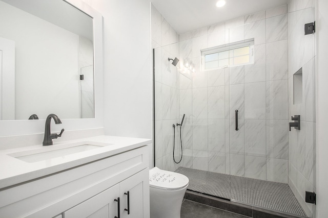 bathroom with tile patterned floors, vanity, toilet, and a shower with shower door