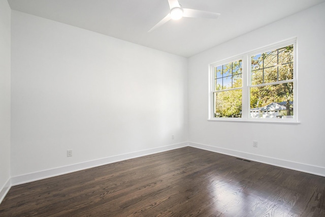 unfurnished room with dark hardwood / wood-style flooring and ceiling fan