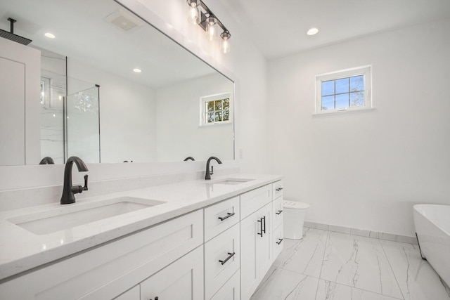 bathroom featuring shower with separate bathtub and vanity