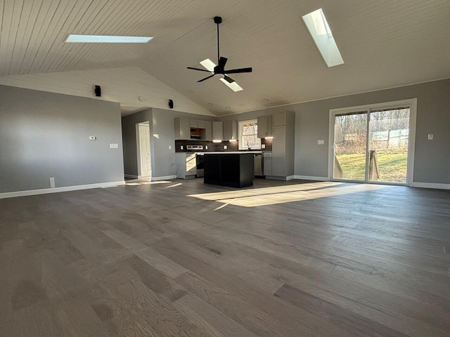 unfurnished living room with hardwood / wood-style floors, ceiling fan, and high vaulted ceiling