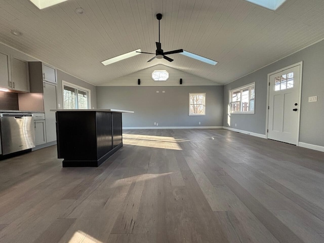 unfurnished living room with wood-type flooring, ceiling fan, wooden ceiling, and vaulted ceiling with skylight