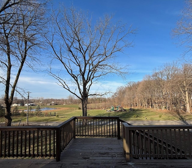 wooden terrace with a lawn and a rural view