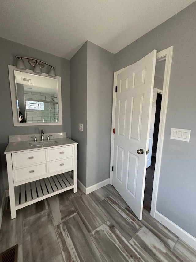 bathroom with vanity and wood-type flooring