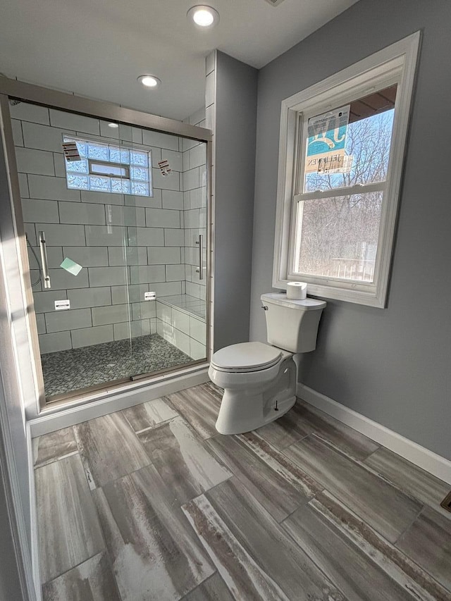 bathroom featuring toilet and walk in shower