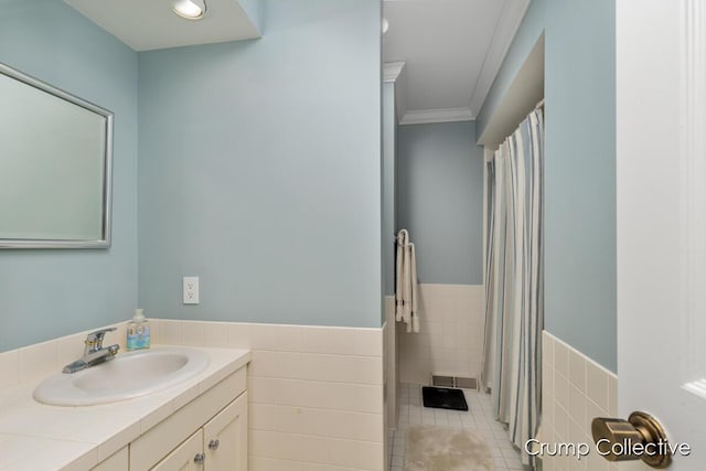 bathroom featuring tile patterned floors, vanity, tile walls, and ornamental molding