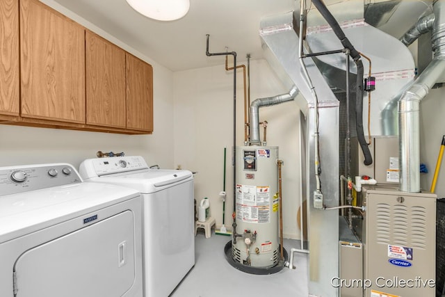 laundry room featuring cabinets, washing machine and dryer, gas water heater, and heating unit