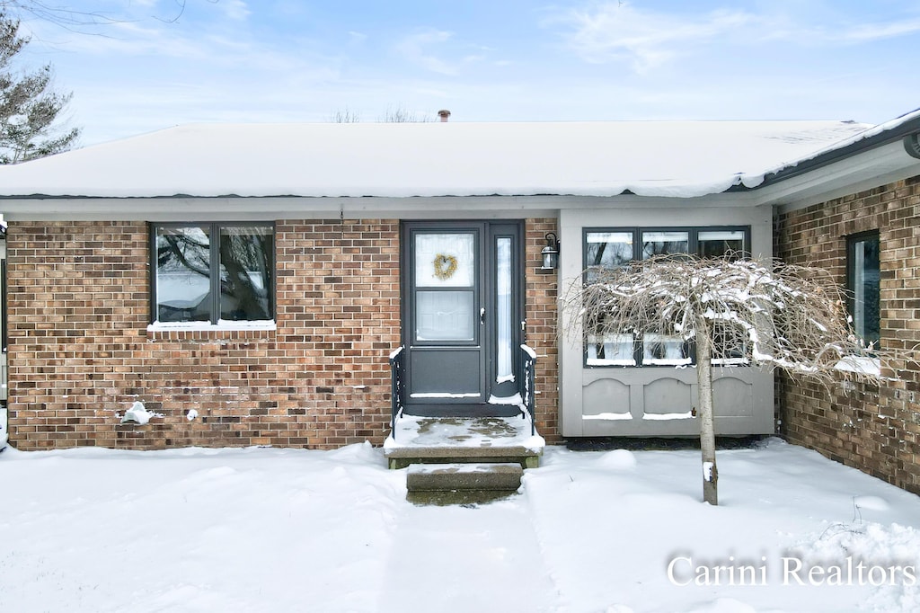 view of snow covered property entrance