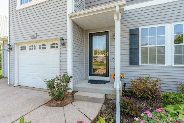 view of exterior entry with a garage