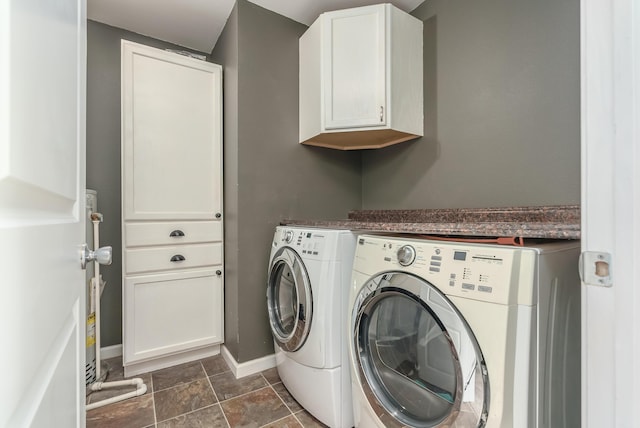 washroom featuring cabinets and independent washer and dryer