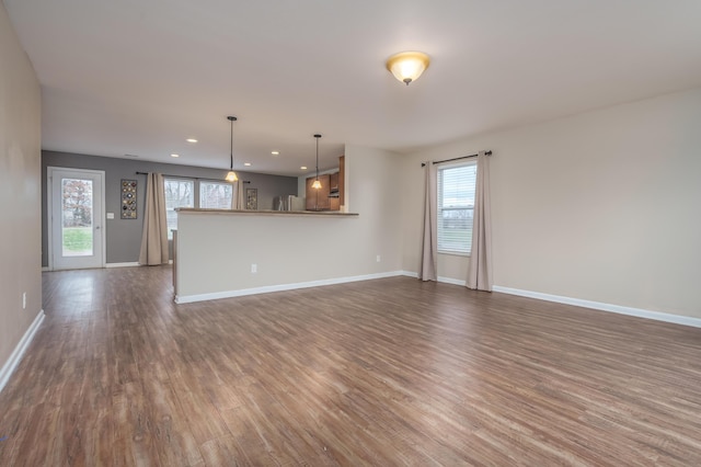 unfurnished living room featuring dark wood-type flooring